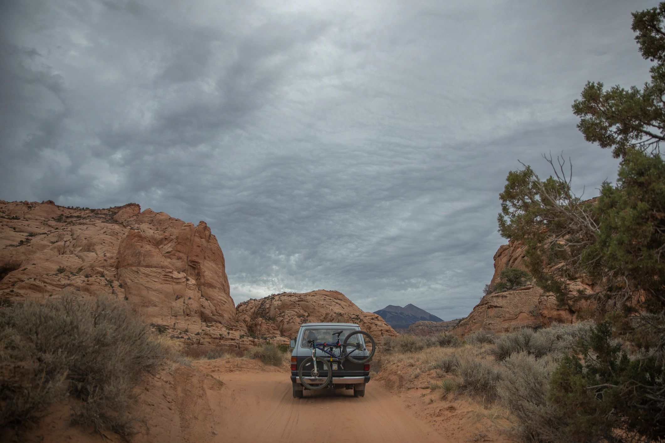 Adventure vehicle parked beside a rugged dirt road