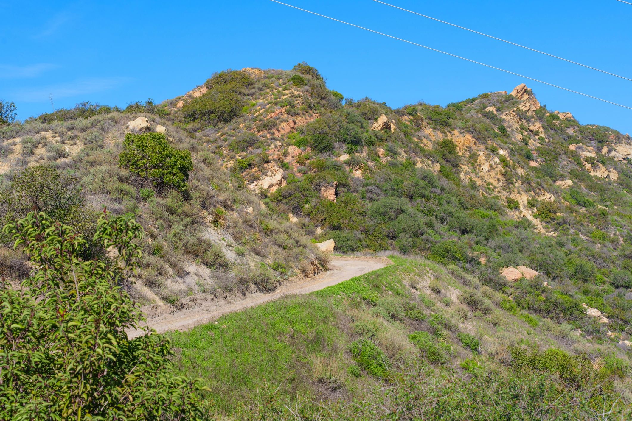 Trail leading through rugged hills toward an overlook