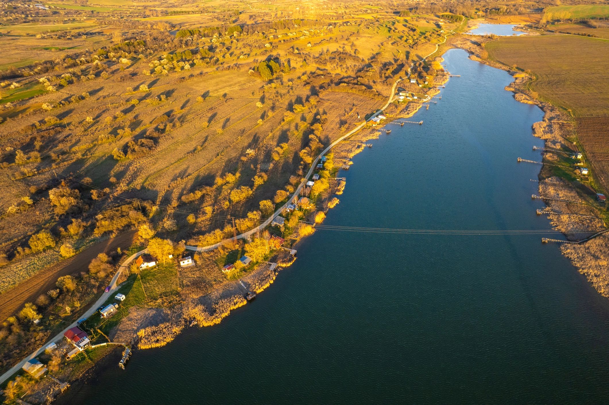 Tranquil river landscape winding through the countryside at sunset